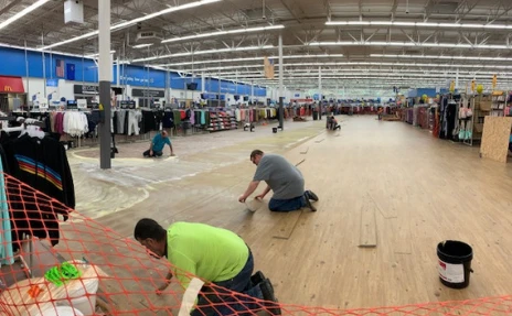 workers laying flooring